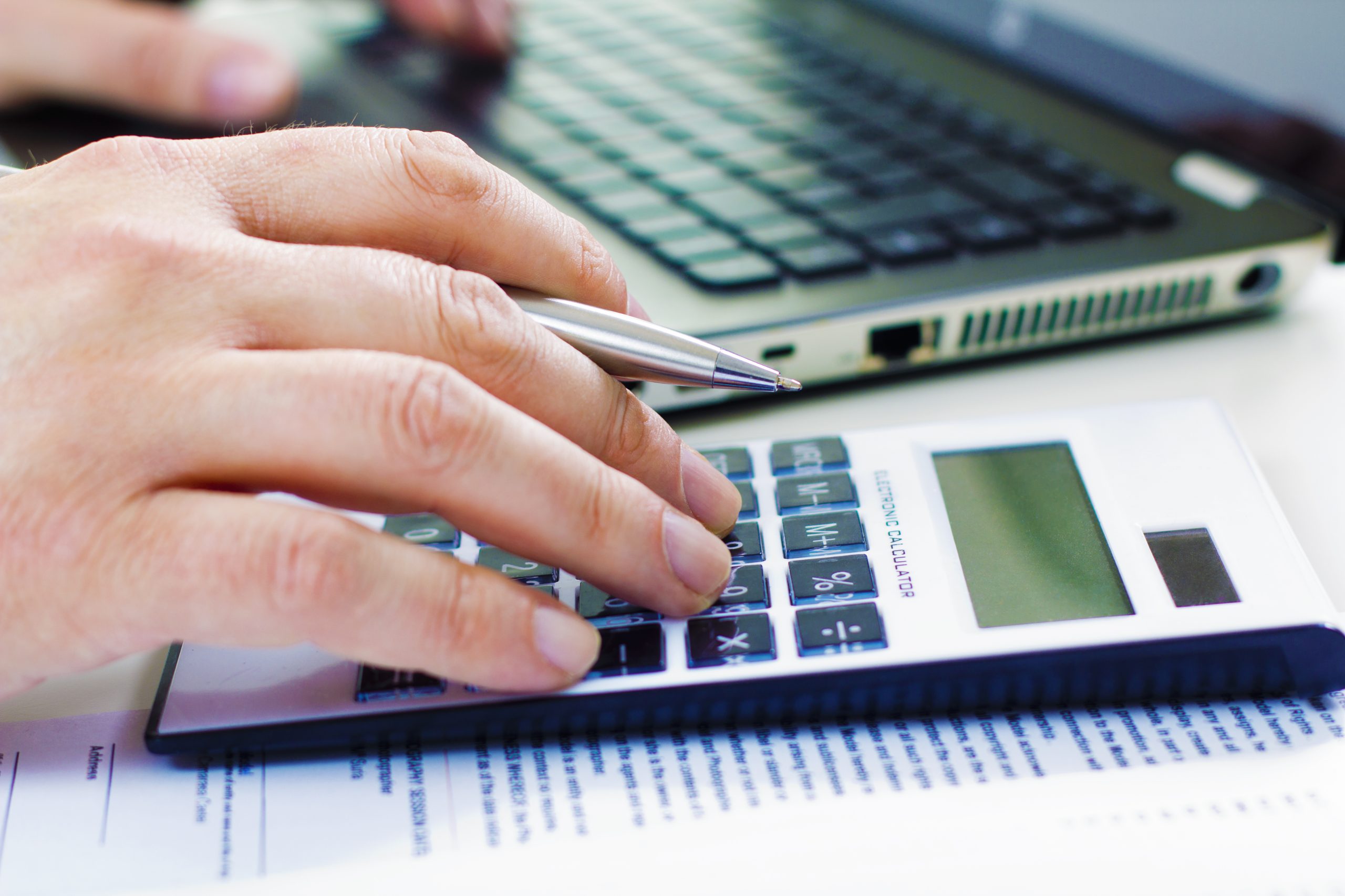 Business man in dark suit whit calculator